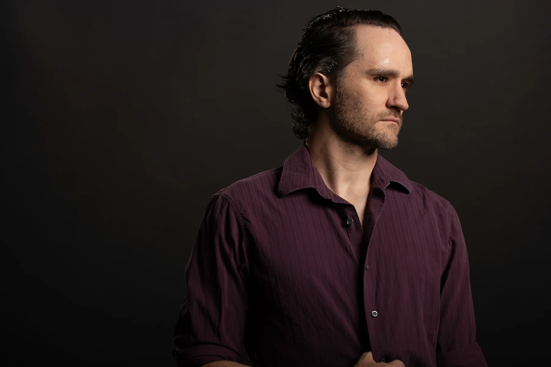 Jacques du Plessis in a burgundy shirt against a dark background