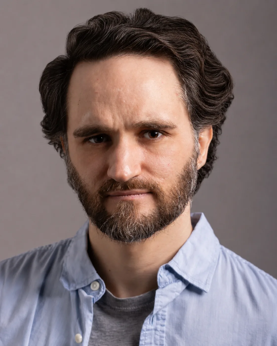 Dramatic headshot of Jacques du Plessis in a light blue shirt
